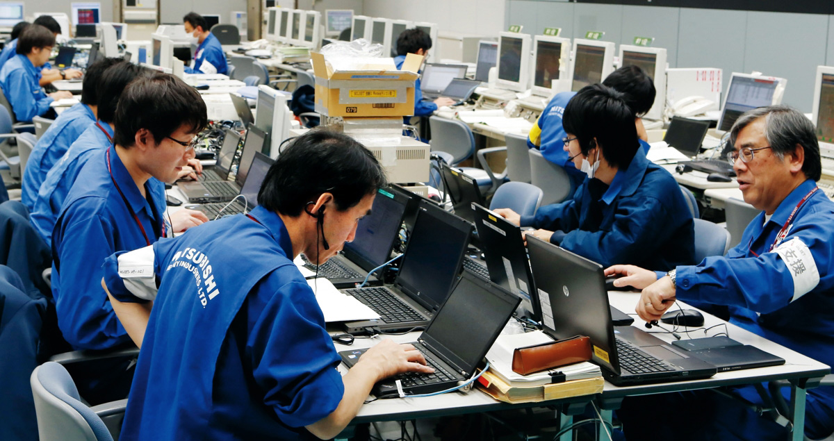 At 5:59 a.m. the atmosphere is tense in the launch control room, as 126 people check and recheck progress on the site.